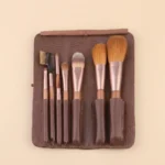 7-piece luxury natural hair makeup brush set with rose gold ferrules and brown suede clutch